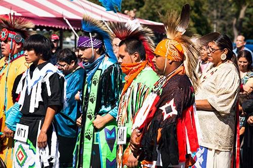 Men in traditional garb stand at attention