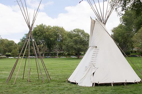 Two tepees on the Fort Omaha Fairground, one without the canvas