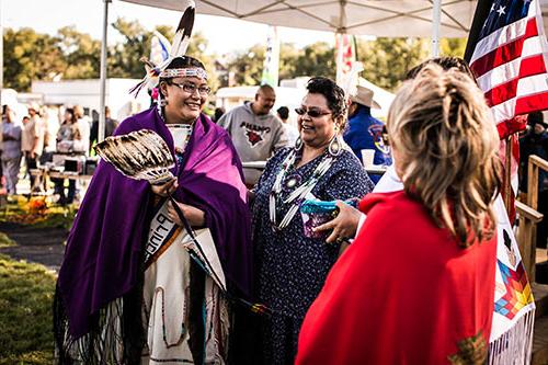 Women gather next to the Powwow Princess